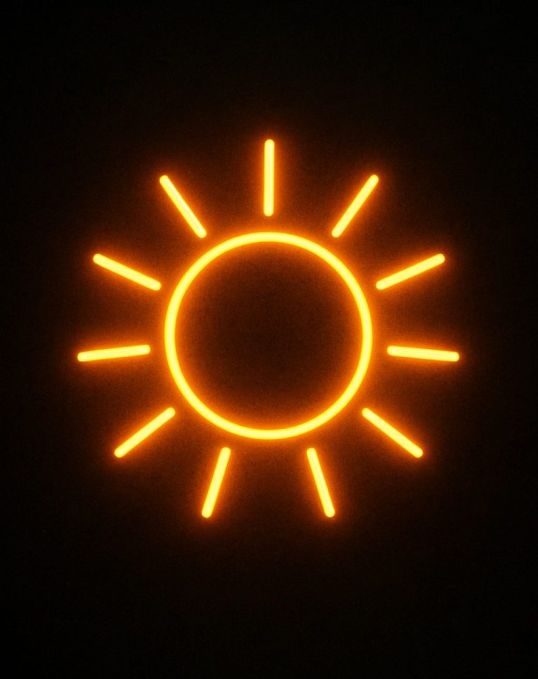Eine abstrakte Sonne als Neonbild auf Backsteinwand